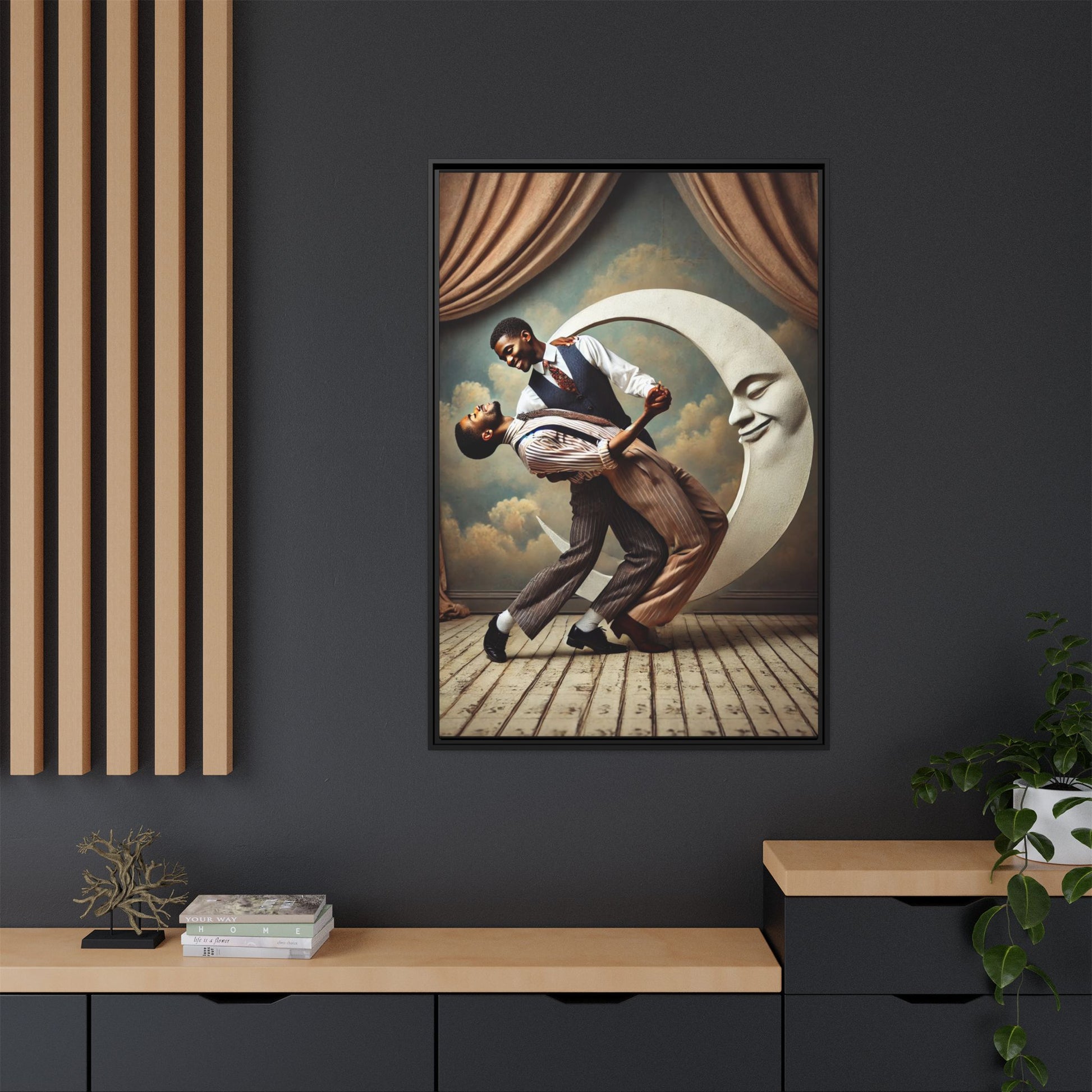 Framed artwork of two Black men in vintage suits dancing tenderly beneath a crescent moon with a smiling face. A romantic 1920s-inspired scene with velvet curtains and a painted sky backdrop. Part of a collection reclaiming lost queer Black history and art.