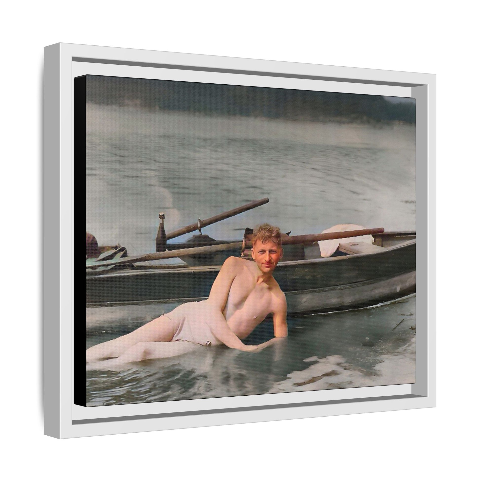 Restored vintage photo of Claude reclining by a rowboat on a calm lake in early 1900s Green Bay, Wisconsin. Framed matte canvas art celebrating serenity, history, and individuality.