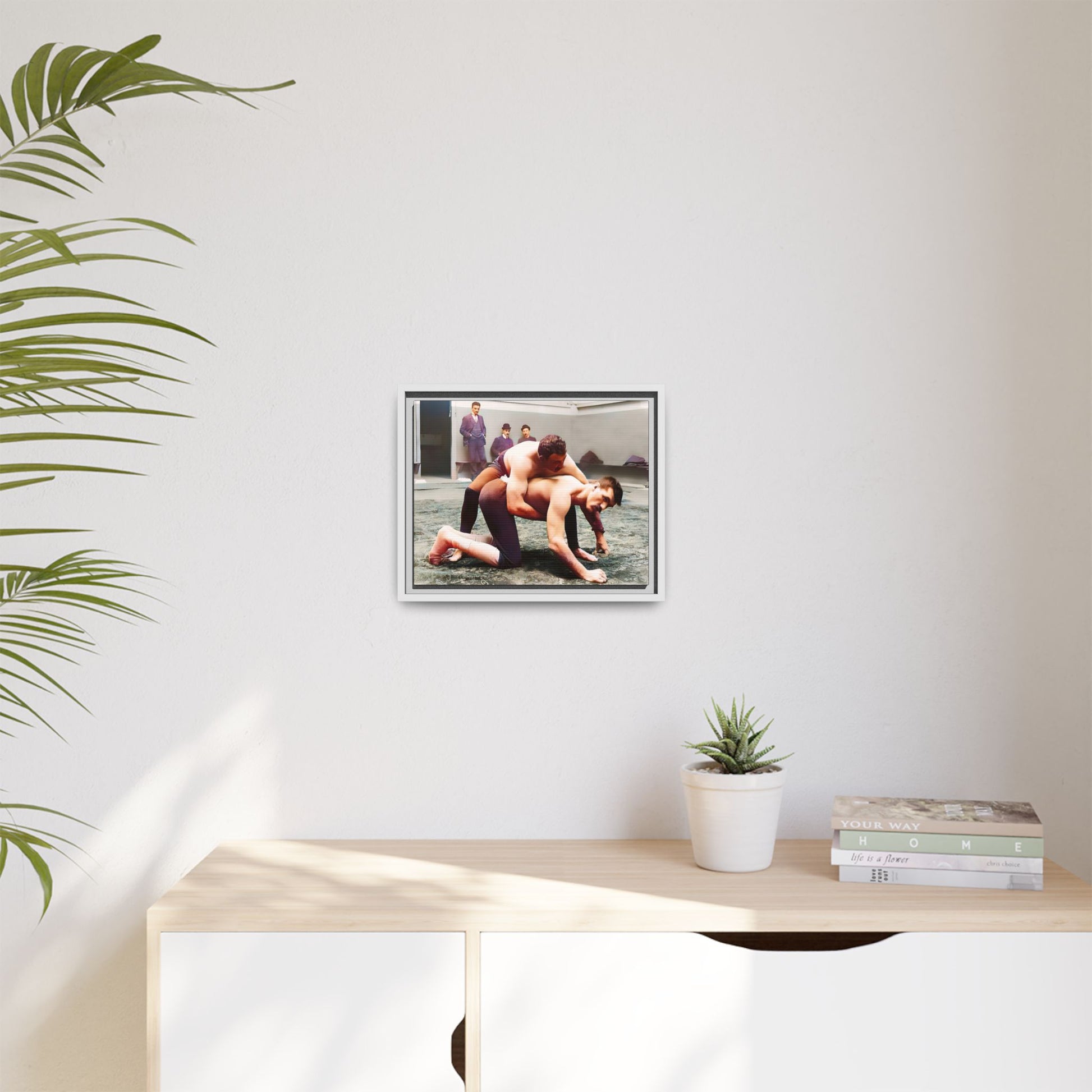 A framed vintage wrestling photograph on matte canvas featuring a Victorian-era match at Love’s Wrestling Club in Plumstead, UK, capturing strength and camaraderie.