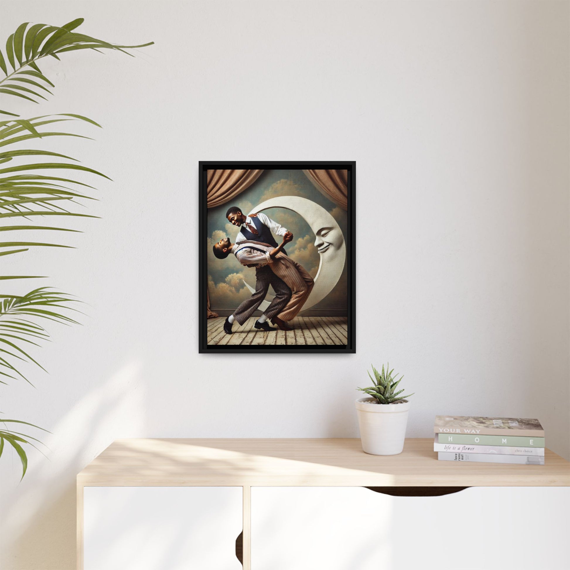 Framed artwork of two Black men in vintage suits dancing tenderly beneath a crescent moon with a smiling face. A romantic 1920s-inspired scene with velvet curtains and a painted sky backdrop. Part of a collection reclaiming lost queer Black history and art.