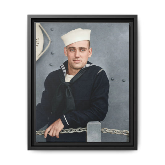 Colorized historical portrait of a man in a white sailor cap and dark striped-collar jumper, with one hand resting over a chain against riveted metal plating.
