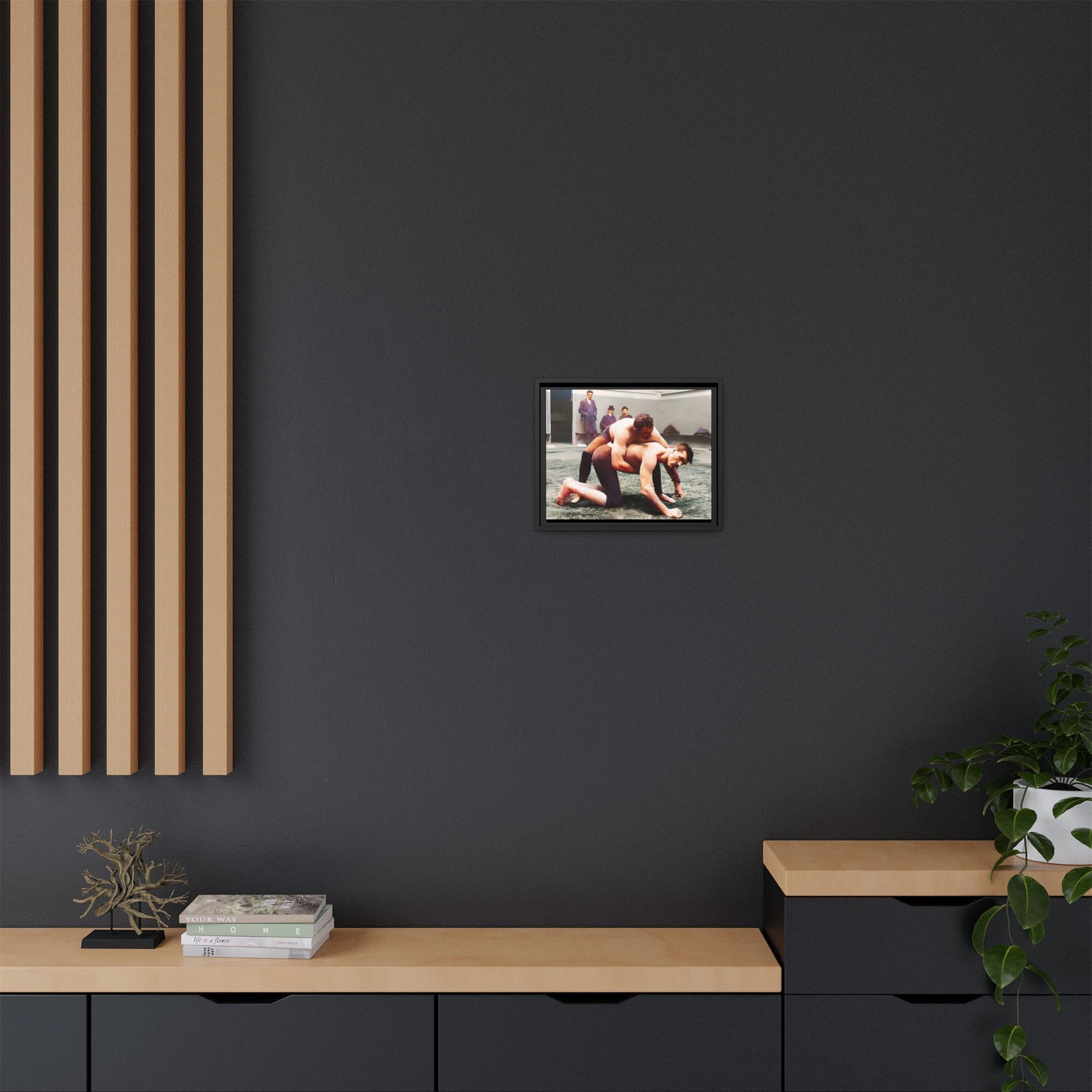 A framed vintage wrestling photograph on matte canvas featuring a Victorian-era match at Love’s Wrestling Club in Plumstead, UK, capturing strength and camaraderie.