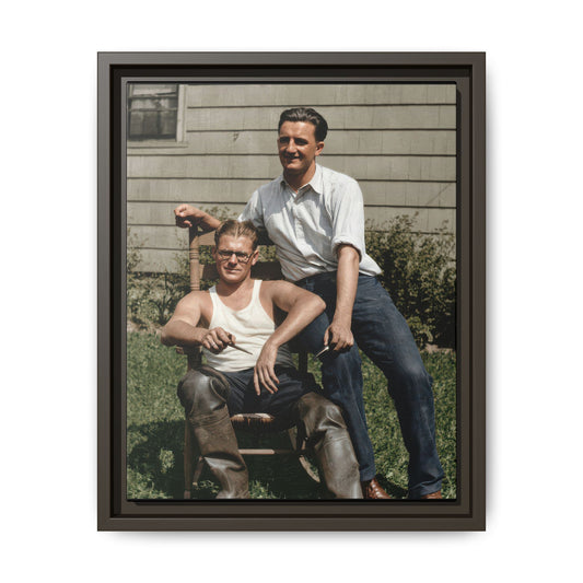 Historic vintage photograph of two men posed outdoors with chair workwear and boots