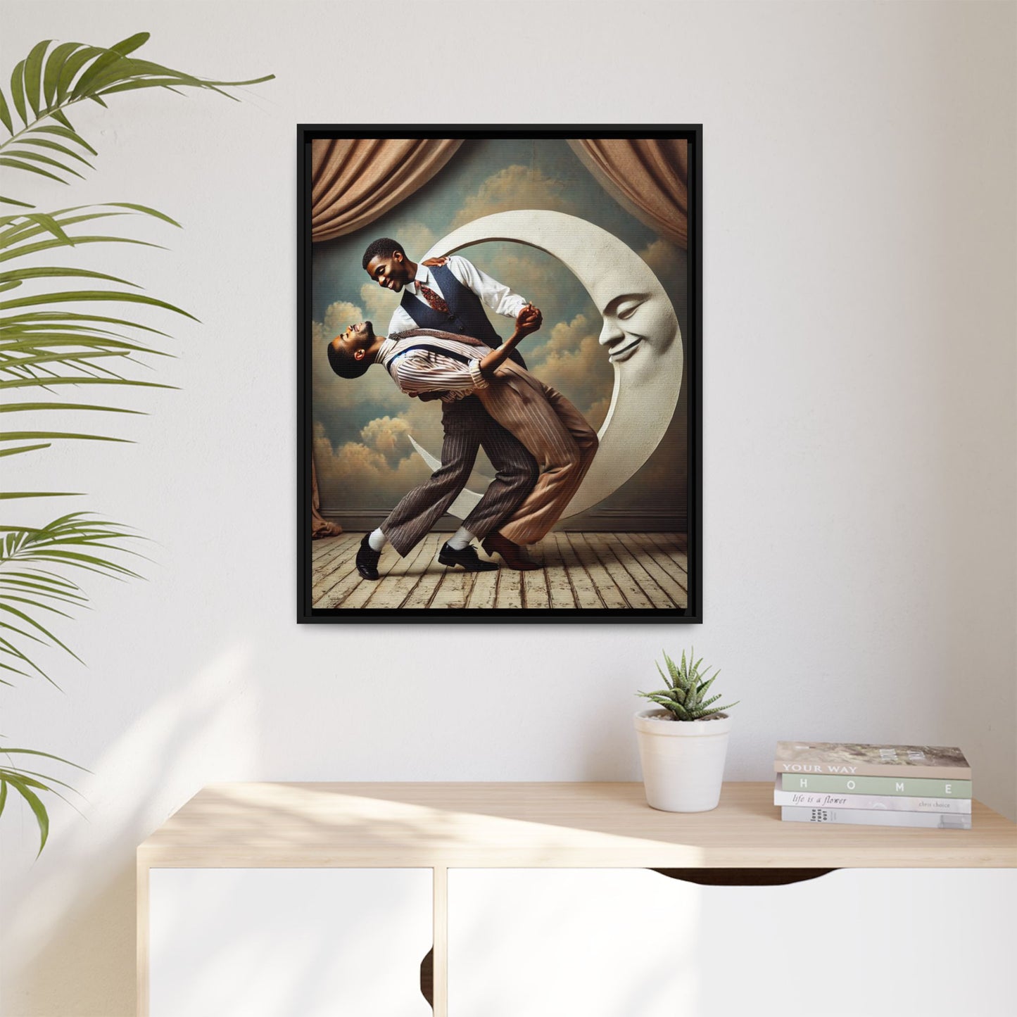 Framed artwork of two Black men in vintage suits dancing tenderly beneath a crescent moon with a smiling face. A romantic 1920s-inspired scene with velvet curtains and a painted sky backdrop. Part of a collection reclaiming lost queer Black history and art.