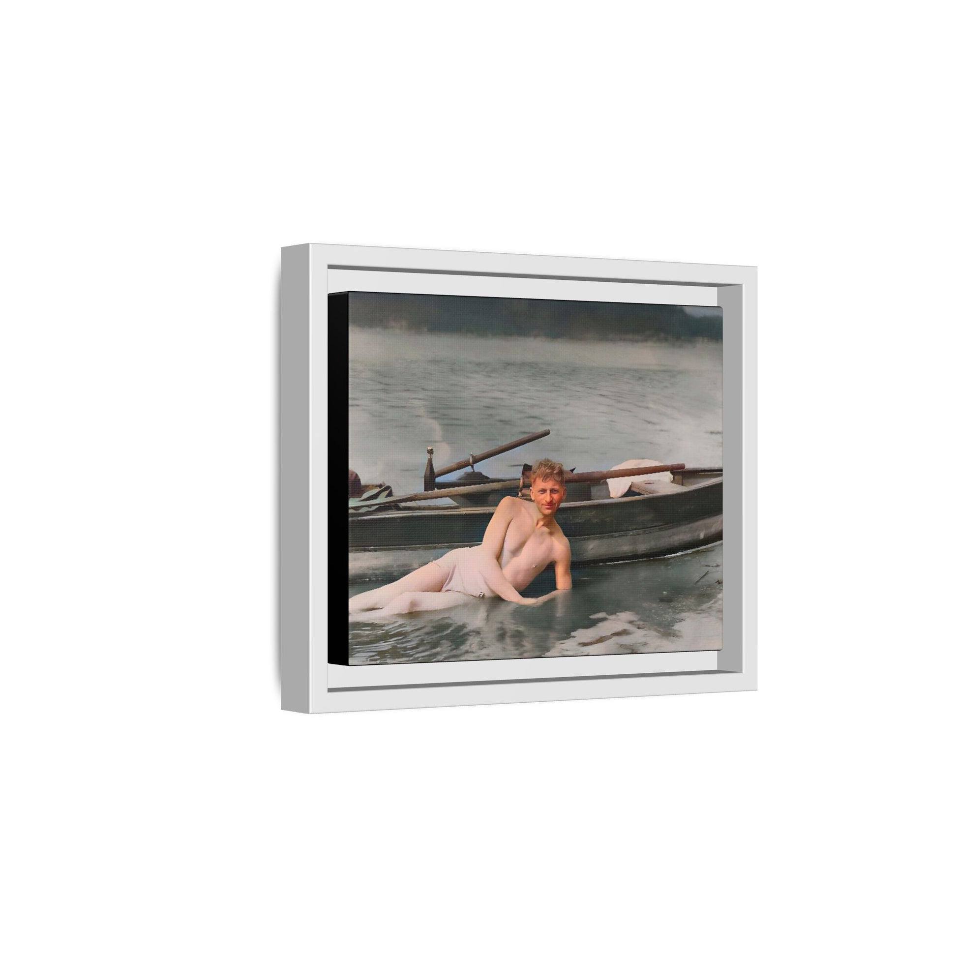 Restored vintage photo of Claude reclining by a rowboat on a calm lake in early 1900s Green Bay, Wisconsin. Framed matte canvas art celebrating serenity, history, and individuality.