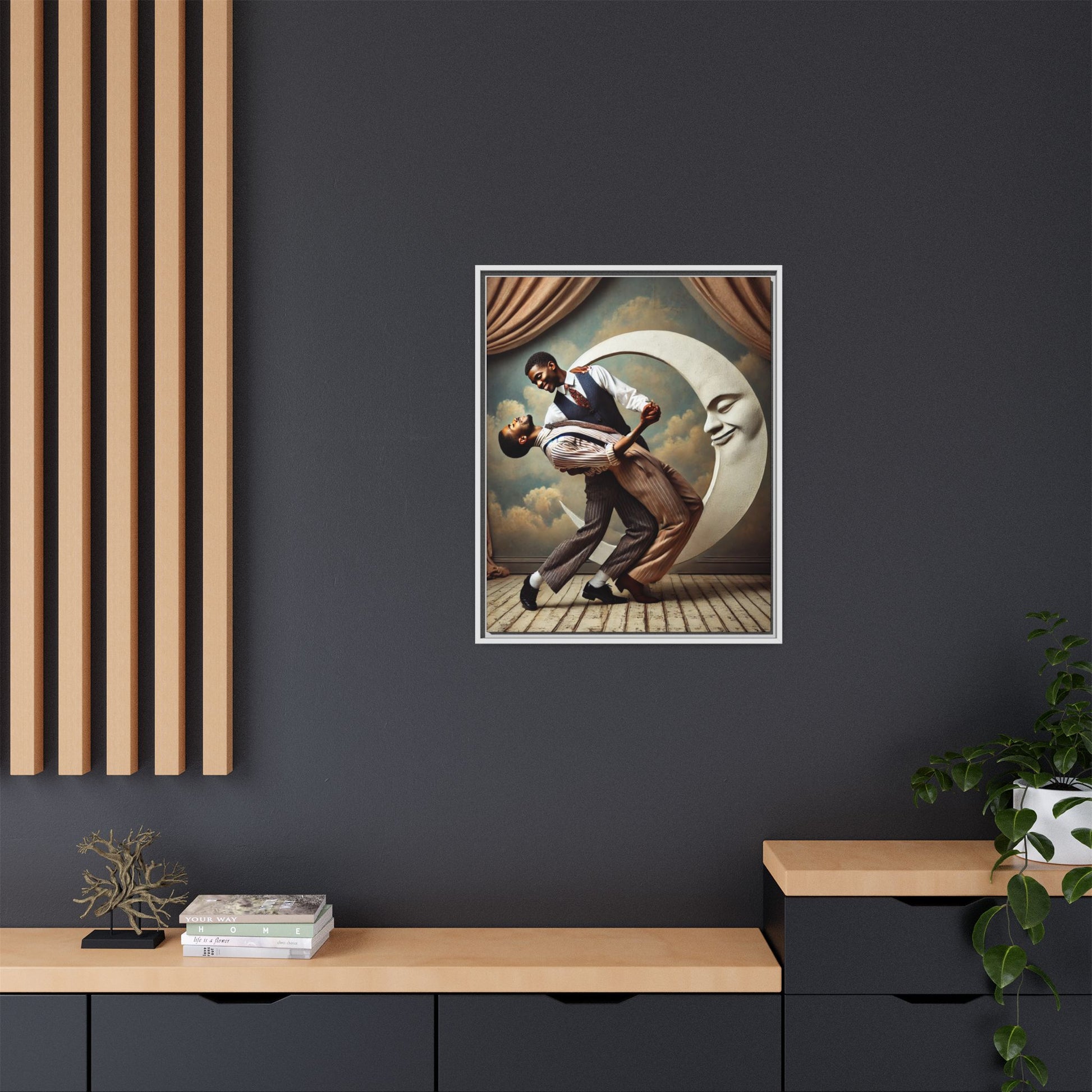Framed artwork of two Black men in vintage suits dancing tenderly beneath a crescent moon with a smiling face. A romantic 1920s-inspired scene with velvet curtains and a painted sky backdrop. Part of a collection reclaiming lost queer Black history and art.