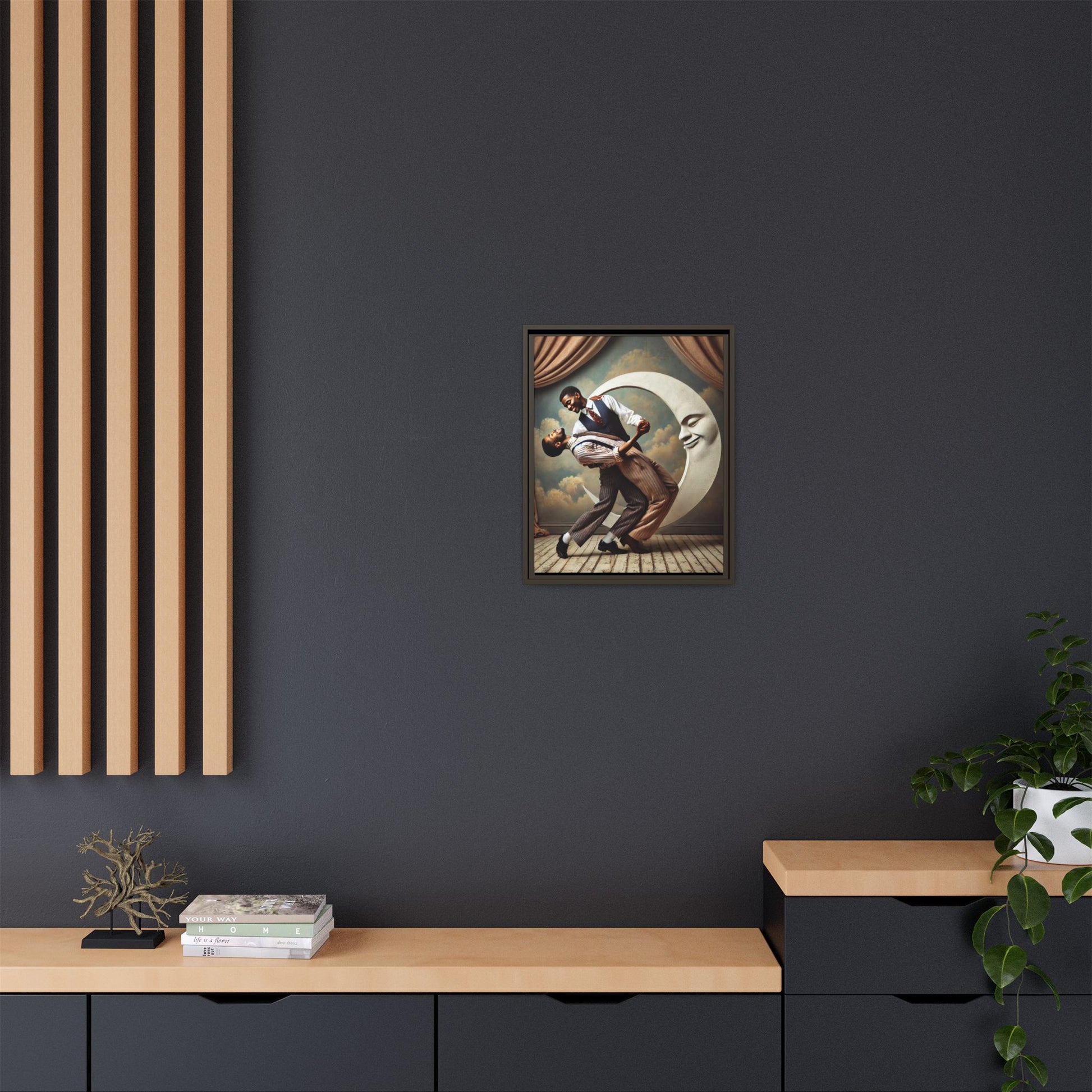 Framed artwork of two Black men in vintage suits dancing tenderly beneath a crescent moon with a smiling face. A romantic 1920s-inspired scene with velvet curtains and a painted sky backdrop. Part of a collection reclaiming lost queer Black history and art.