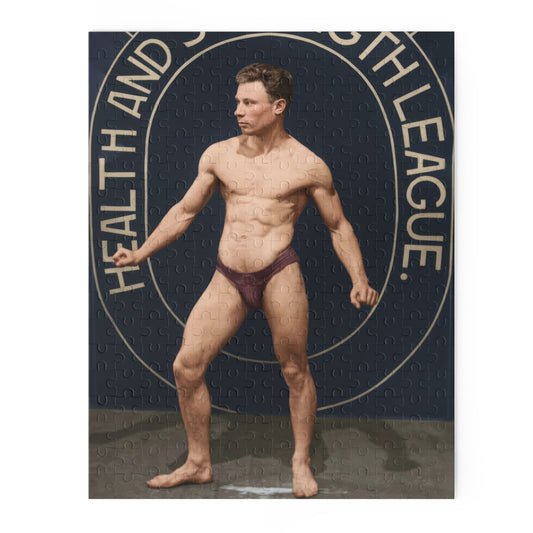 Colorized portrait displayed sideways of a barefoot male athlete in burgundy trunks before a navy “Health and Strength League” backdrop with cream oval outlines.
