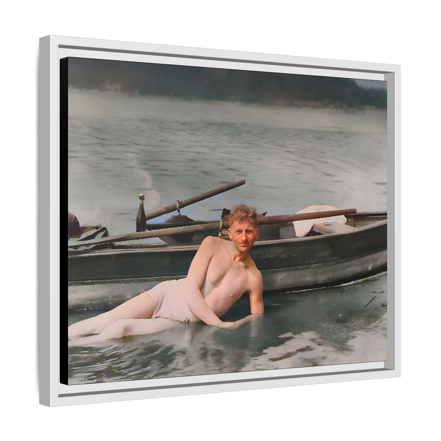 Restored vintage photo of Claude reclining by a rowboat on a calm lake in early 1900s Green Bay, Wisconsin. Framed matte canvas art celebrating serenity, history, and individuality.