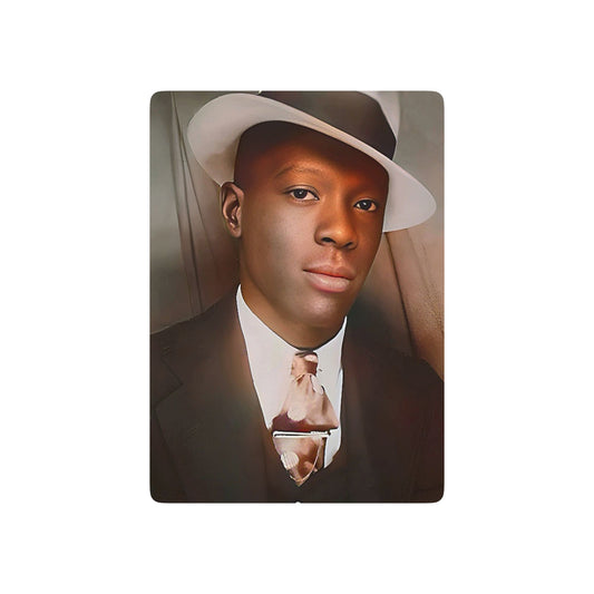 Vintage photo of a stylish African American man in a fedora and suit, seated in a classic mid-century photo booth.