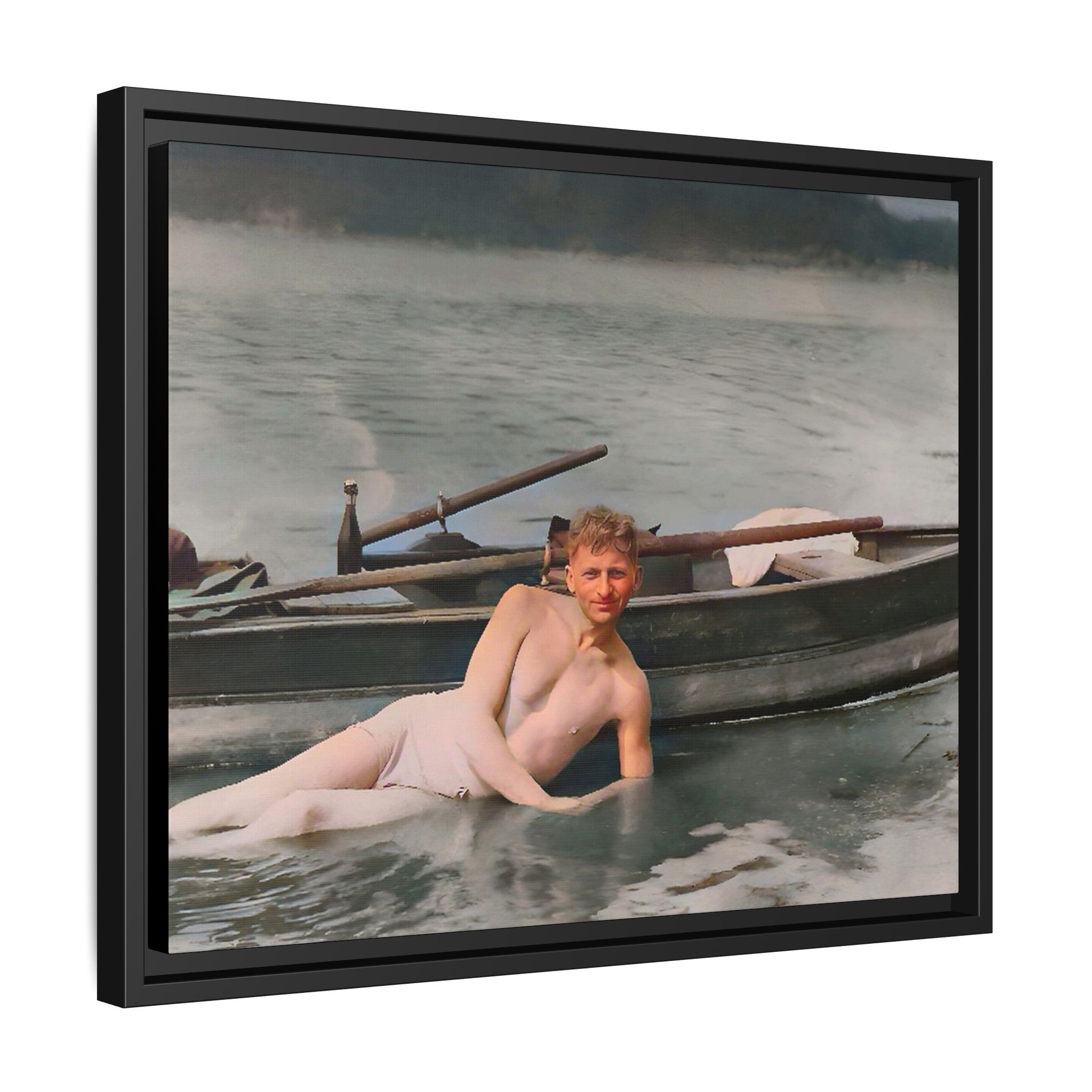Restored vintage photo of Claude reclining by a rowboat on a calm lake in early 1900s Green Bay, Wisconsin. Framed matte canvas art celebrating serenity, history, and individuality.