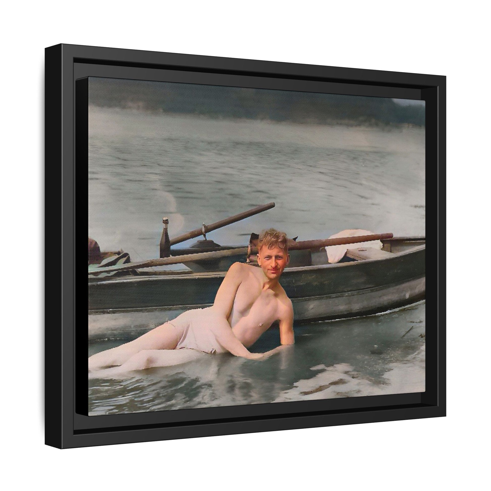 Restored vintage photo of Claude reclining by a rowboat on a calm lake in early 1900s Green Bay, Wisconsin. Framed matte canvas art celebrating serenity, history, and individuality.