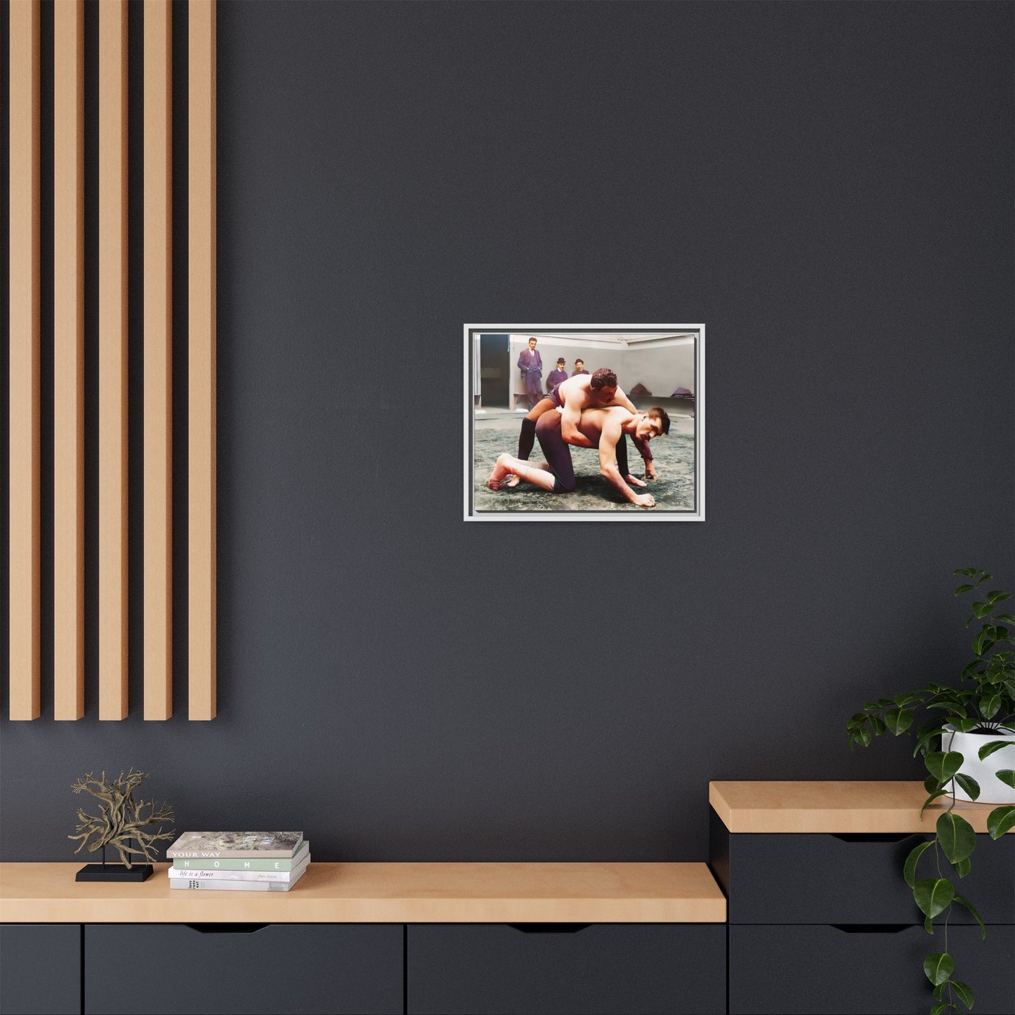 A framed vintage wrestling photograph on matte canvas featuring a Victorian-era match at Love’s Wrestling Club in Plumstead, UK, capturing strength and camaraderie.