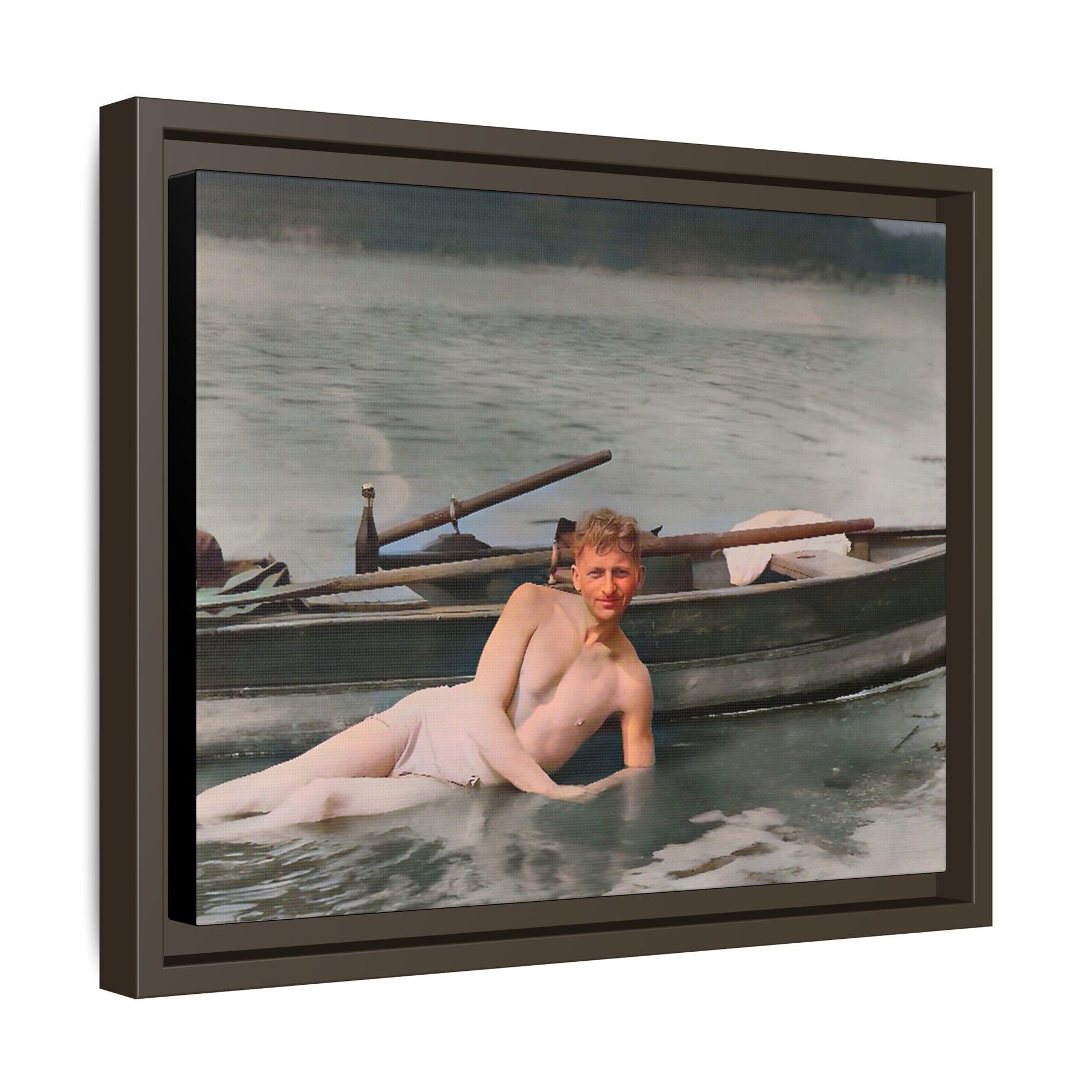 Restored vintage photo of Claude reclining by a rowboat on a calm lake in early 1900s Green Bay, Wisconsin. Framed matte canvas art celebrating serenity, history, and individuality.