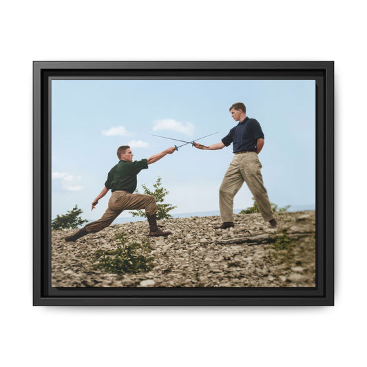 Vintage photograph of two figures practicing fencing with crossed swords on rocky ground near open water