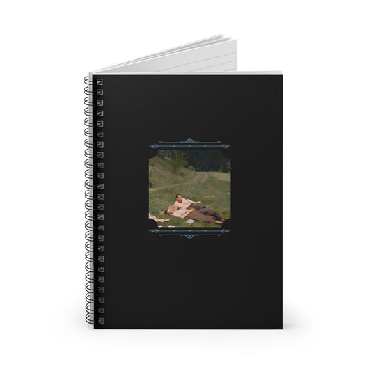 Vintage photo of WWII soldiers embracing in a field, colorized and printed on a ruled spiral notebook.