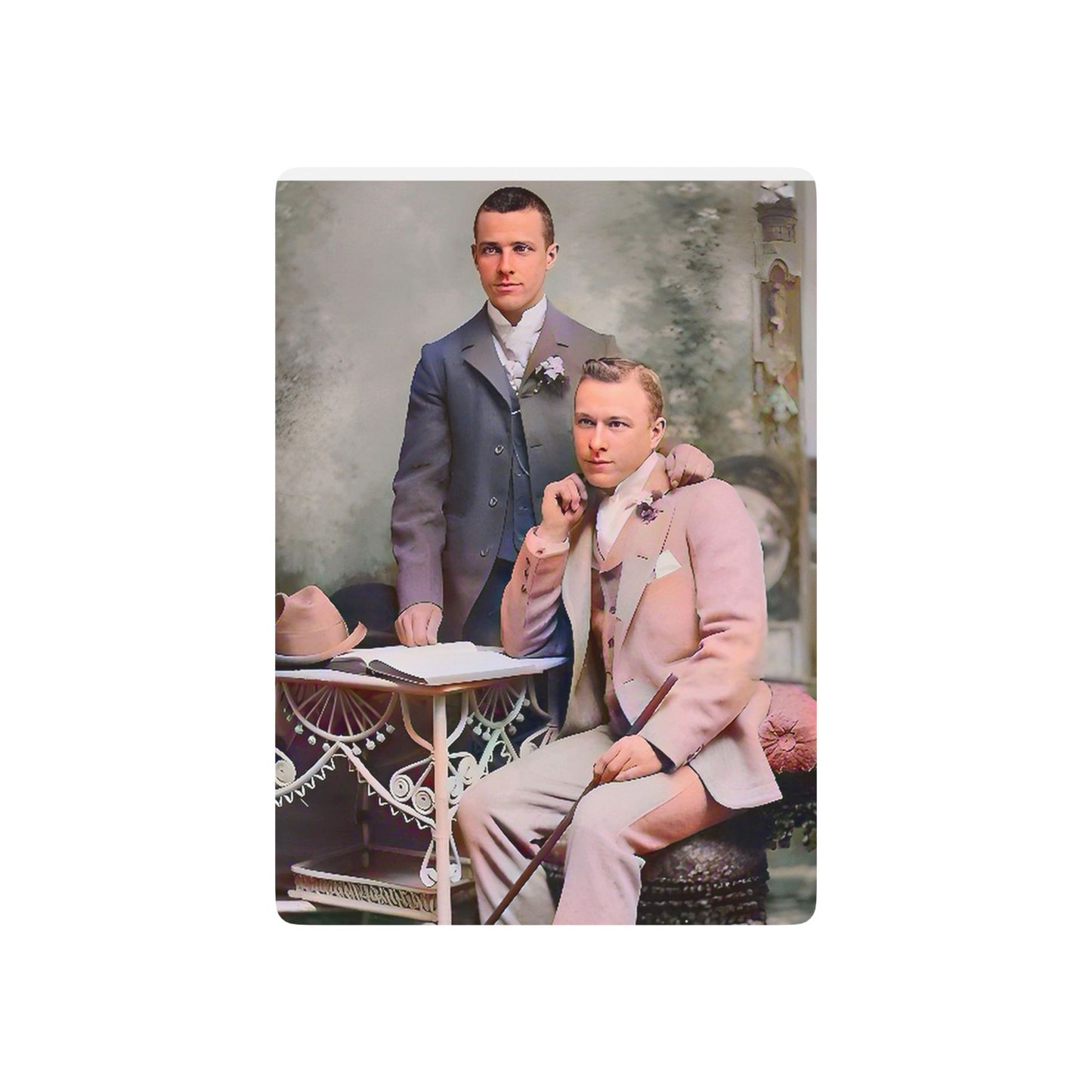 Vintage photo of an elegantly dressed gay couple in a formal studio setting, symbolizing Queer love and resilience.