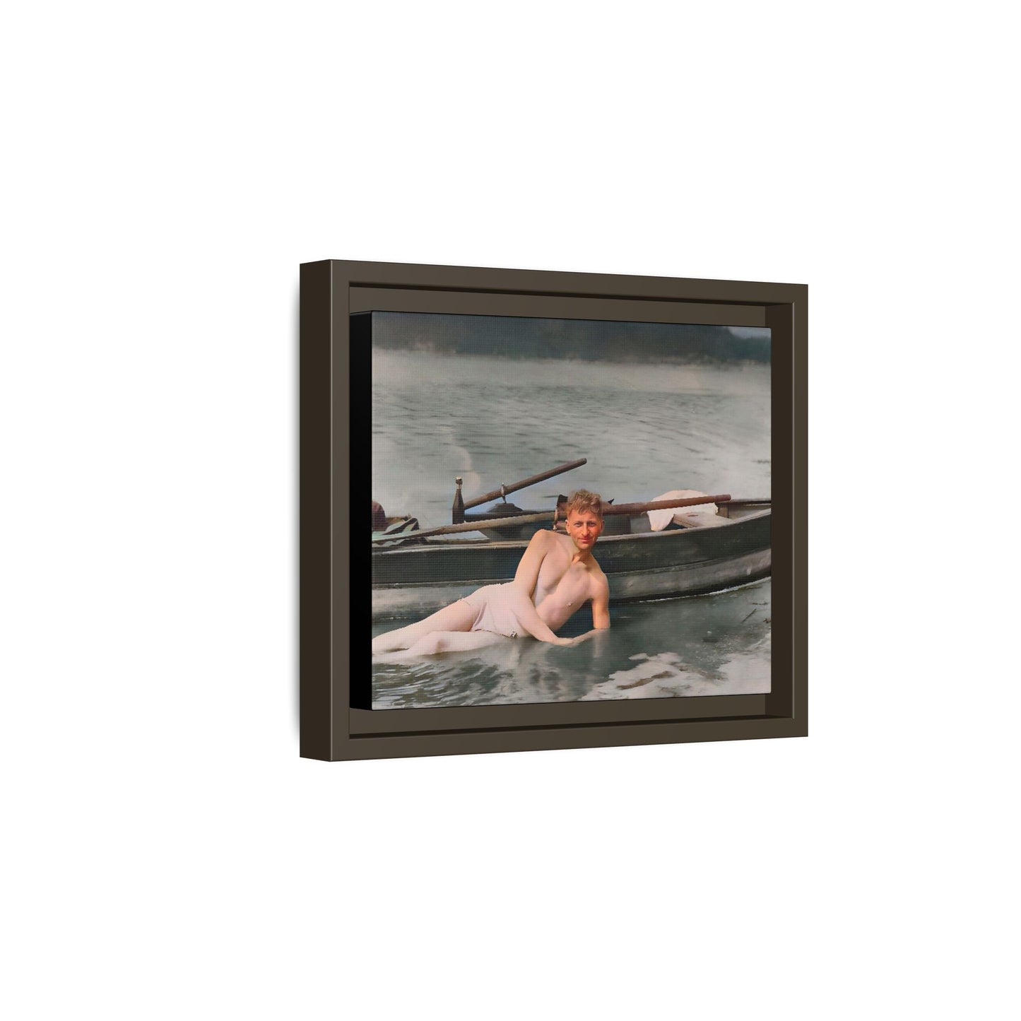 Restored vintage photo of Claude reclining by a rowboat on a calm lake in early 1900s Green Bay, Wisconsin. Framed matte canvas art celebrating serenity, history, and individuality.