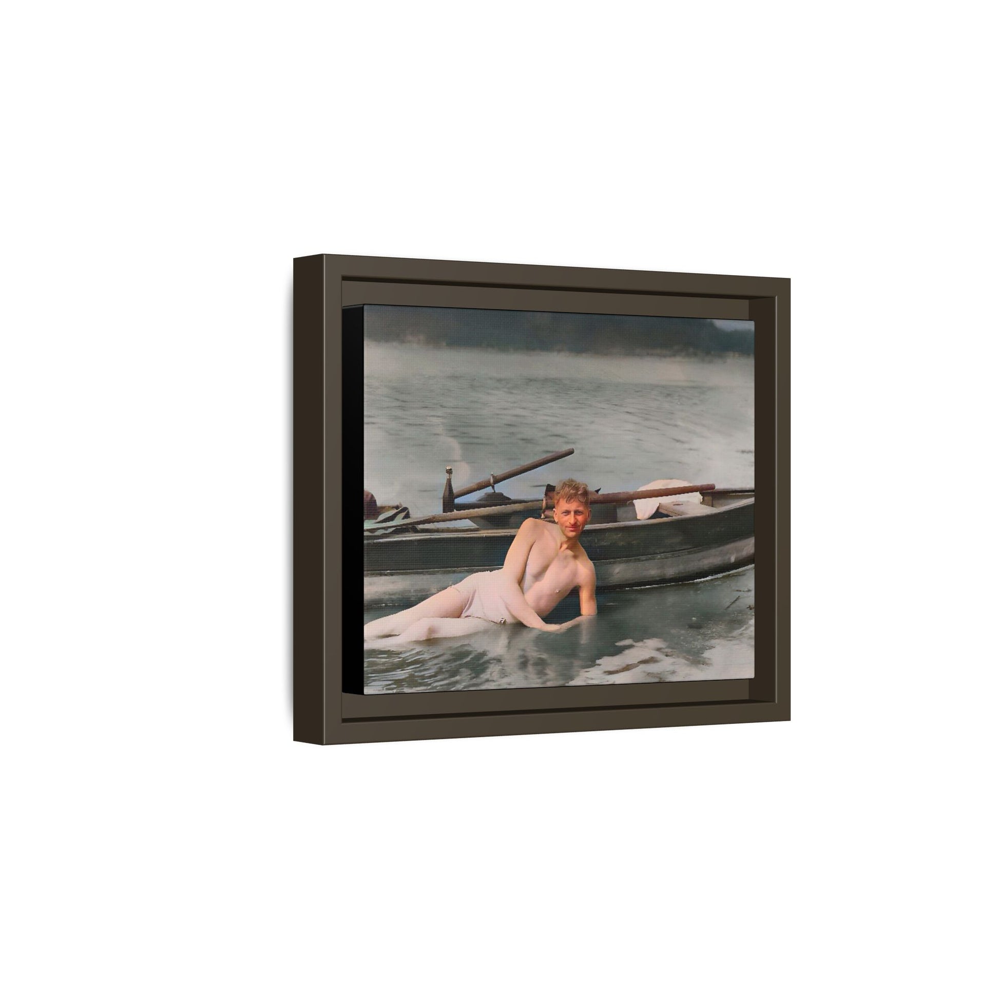 Restored vintage photo of Claude reclining by a rowboat on a calm lake in early 1900s Green Bay, Wisconsin. Framed matte canvas art celebrating serenity, history, and individuality.