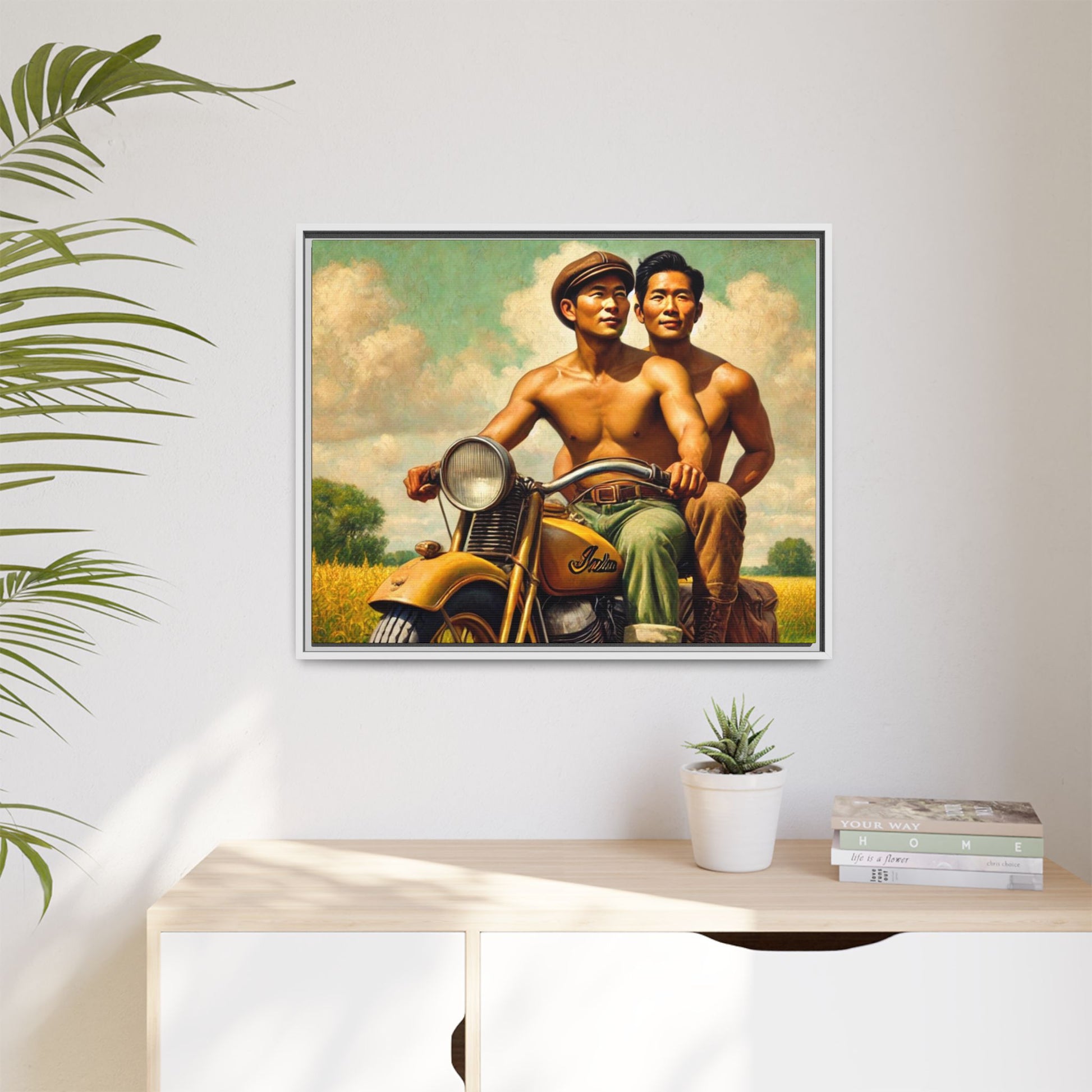 Framed artwork of an Asian-American gay couple riding a vintage yellow motorcycle through Iowa's serene countryside, celebrating love and unity.