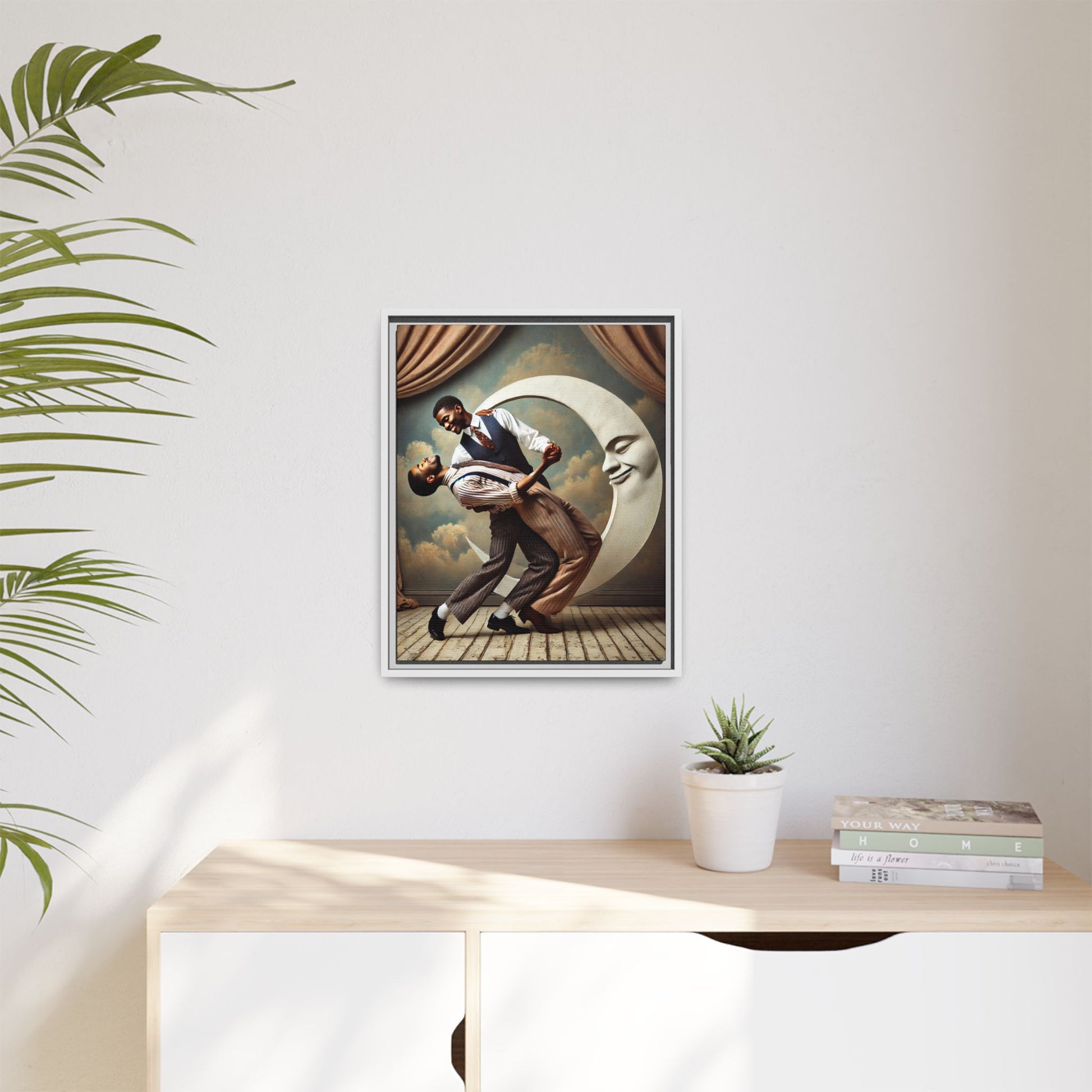 Framed artwork of two Black men in vintage suits dancing tenderly beneath a crescent moon with a smiling face. A romantic 1920s-inspired scene with velvet curtains and a painted sky backdrop. Part of a collection reclaiming lost queer Black history and art.
