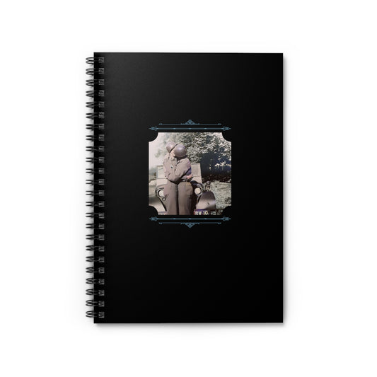 Black spiral notebook with a restored WWII photo of two male soldiers in uniform sharing a kiss beside a army jeep