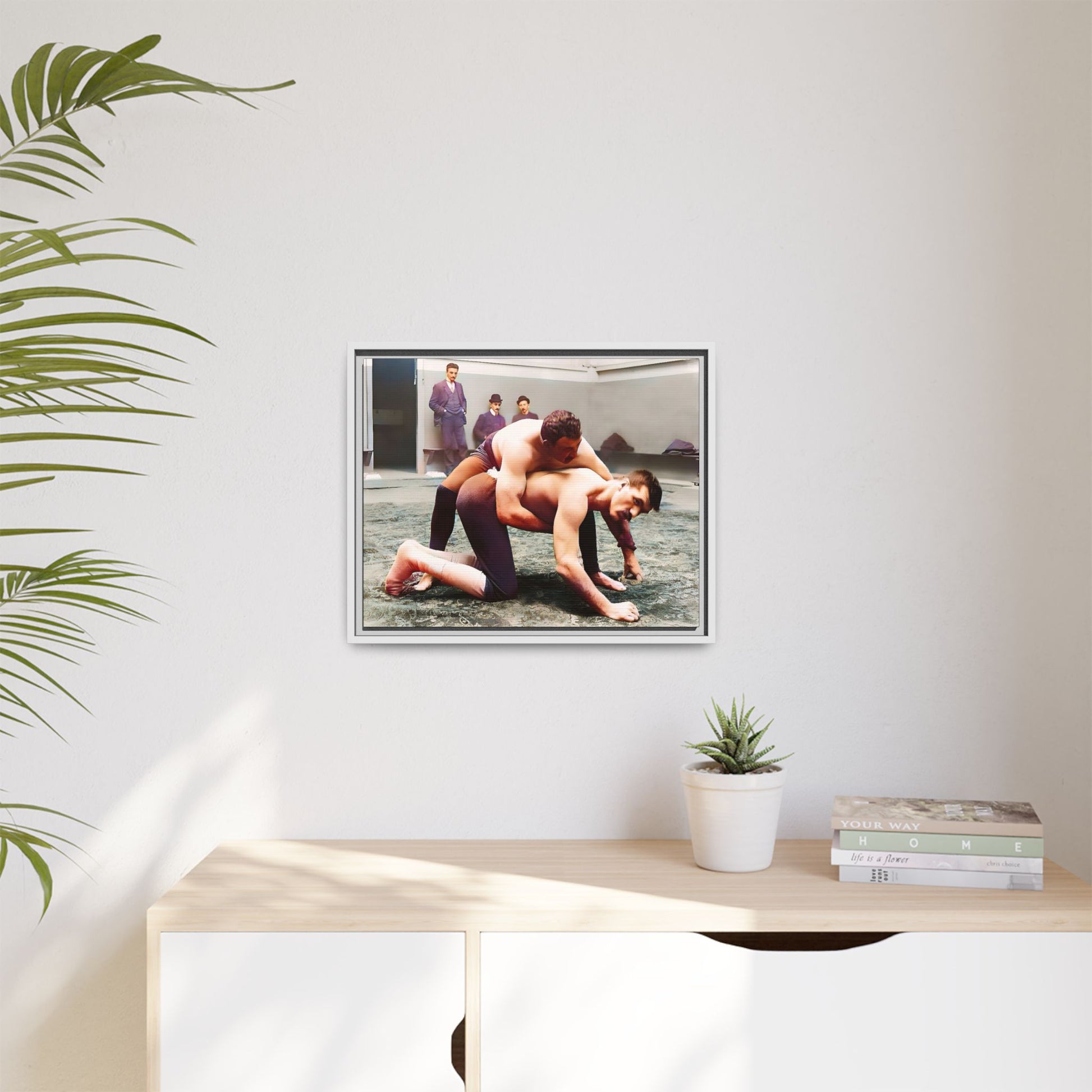 A framed vintage wrestling photograph on matte canvas featuring a Victorian-era match at Love’s Wrestling Club in Plumstead, UK, capturing strength and camaraderie.