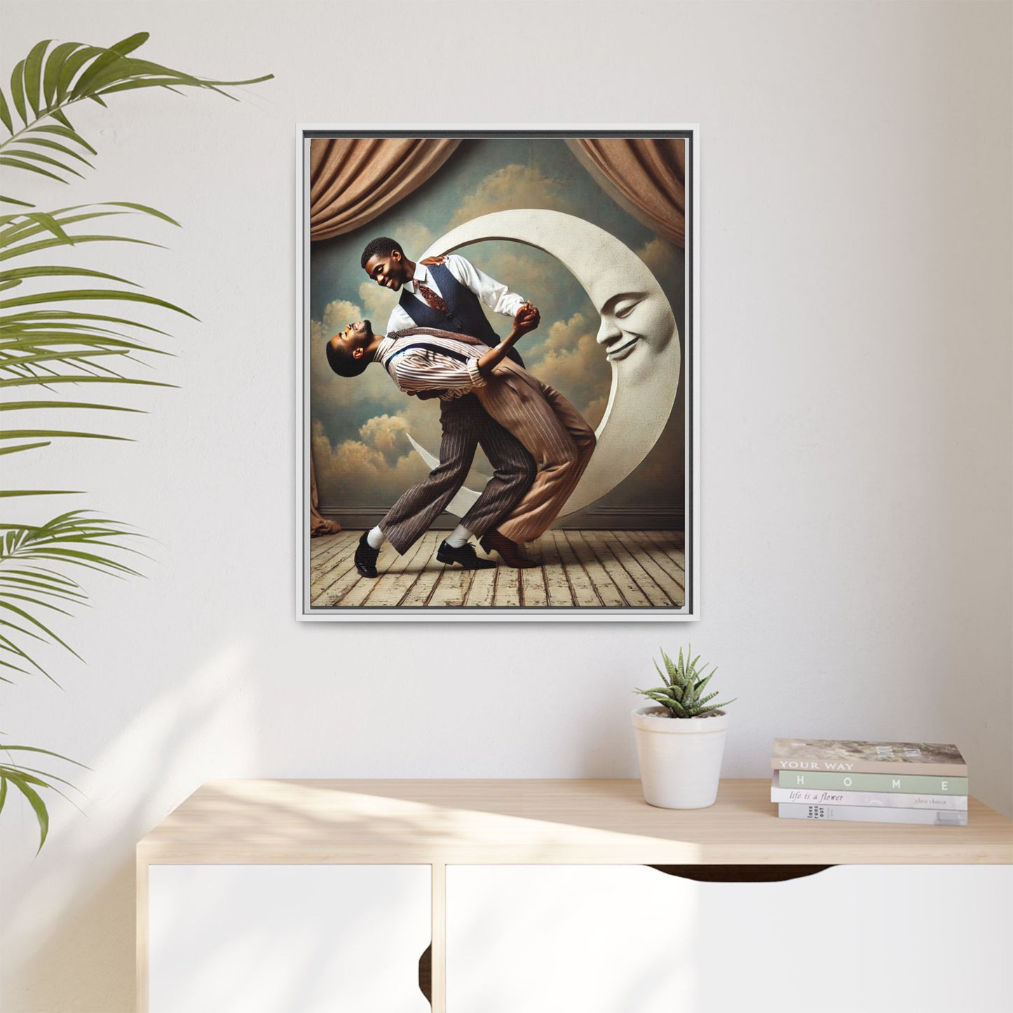Framed artwork of two Black men in vintage suits dancing tenderly beneath a crescent moon with a smiling face. A romantic 1920s-inspired scene with velvet curtains and a painted sky backdrop. Part of a collection reclaiming lost queer Black history and art.