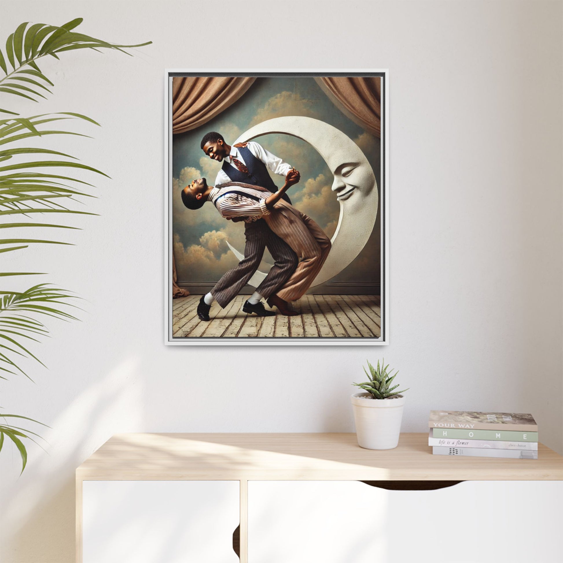Framed artwork of two Black men in vintage suits dancing tenderly beneath a crescent moon with a smiling face. A romantic 1920s-inspired scene with velvet curtains and a painted sky backdrop. Part of a collection reclaiming lost queer Black history and art.