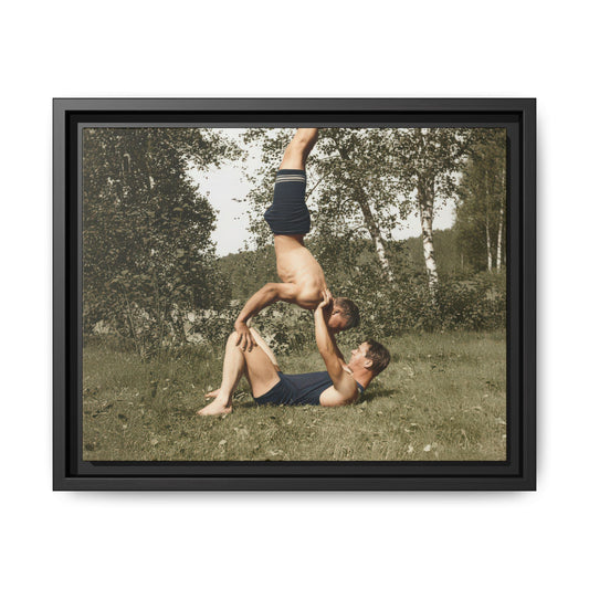 Two figures in vintage swimwear performing acrobatic balance outdoors