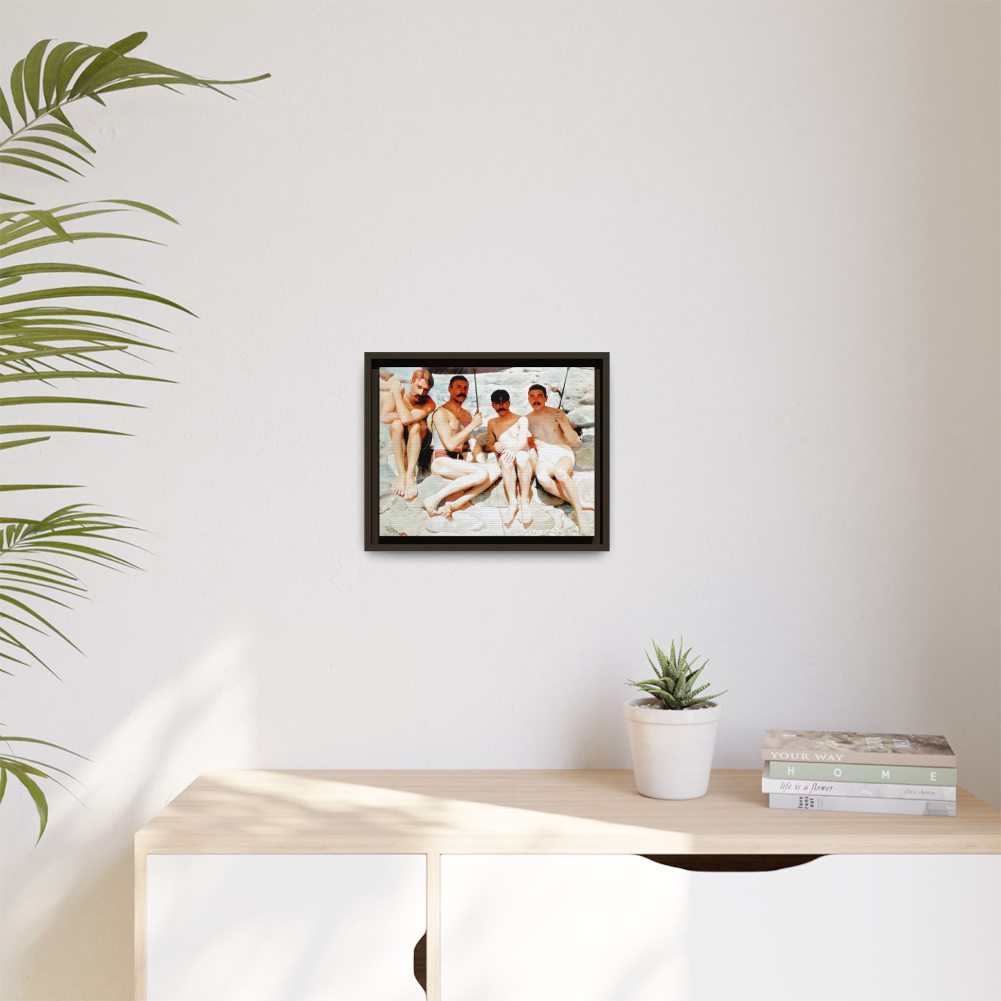 A nostalgic vintage beach photograph from Herring Cove Beach, Provincetown, MA. This framed canvas print captures four men in a relaxed summer moment, perfect for coastal home decor or as an LGBTQ+ history tribute.