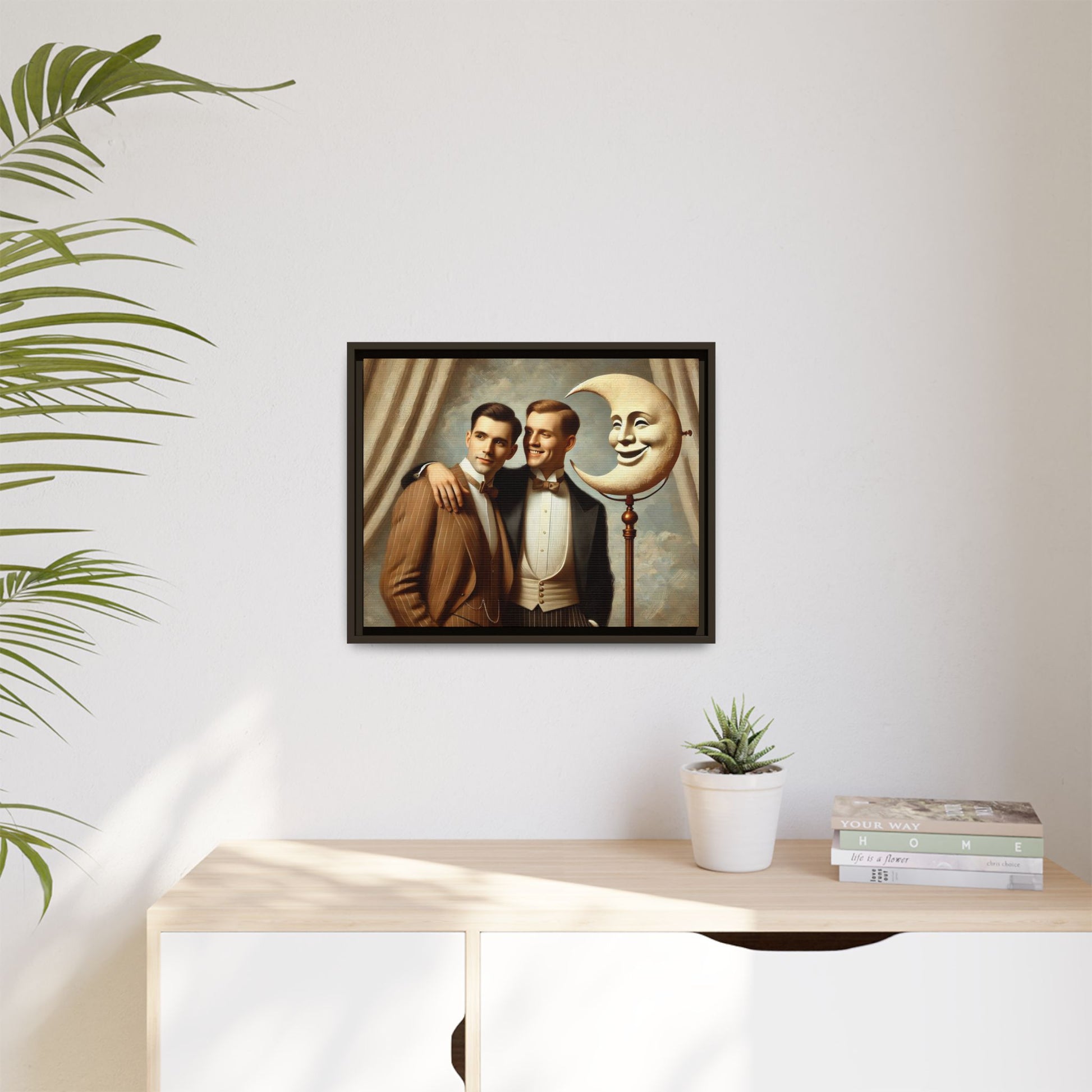 Framed matte canvas artwork of two men in vintage tuxedos standing beside a crescent moon prop. This piece reclaims LGBTQ+ representation lost to bias and honors everyday moments of affection and connection once absent from historical archives.