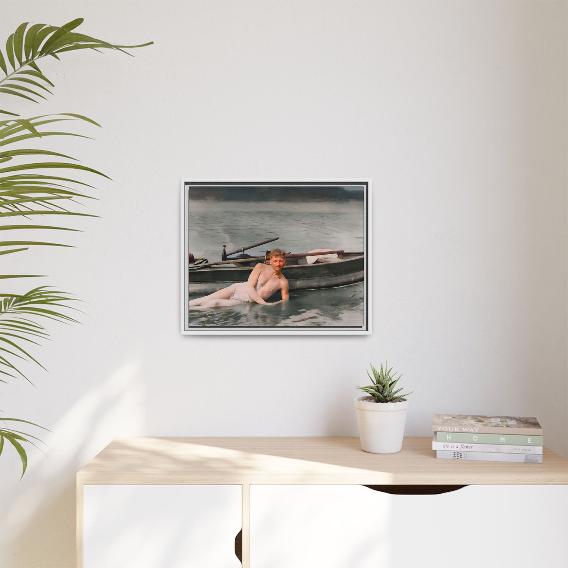 Restored vintage photo of Claude reclining by a rowboat on a calm lake in early 1900s Green Bay, Wisconsin. Framed matte canvas art celebrating serenity, history, and individuality.