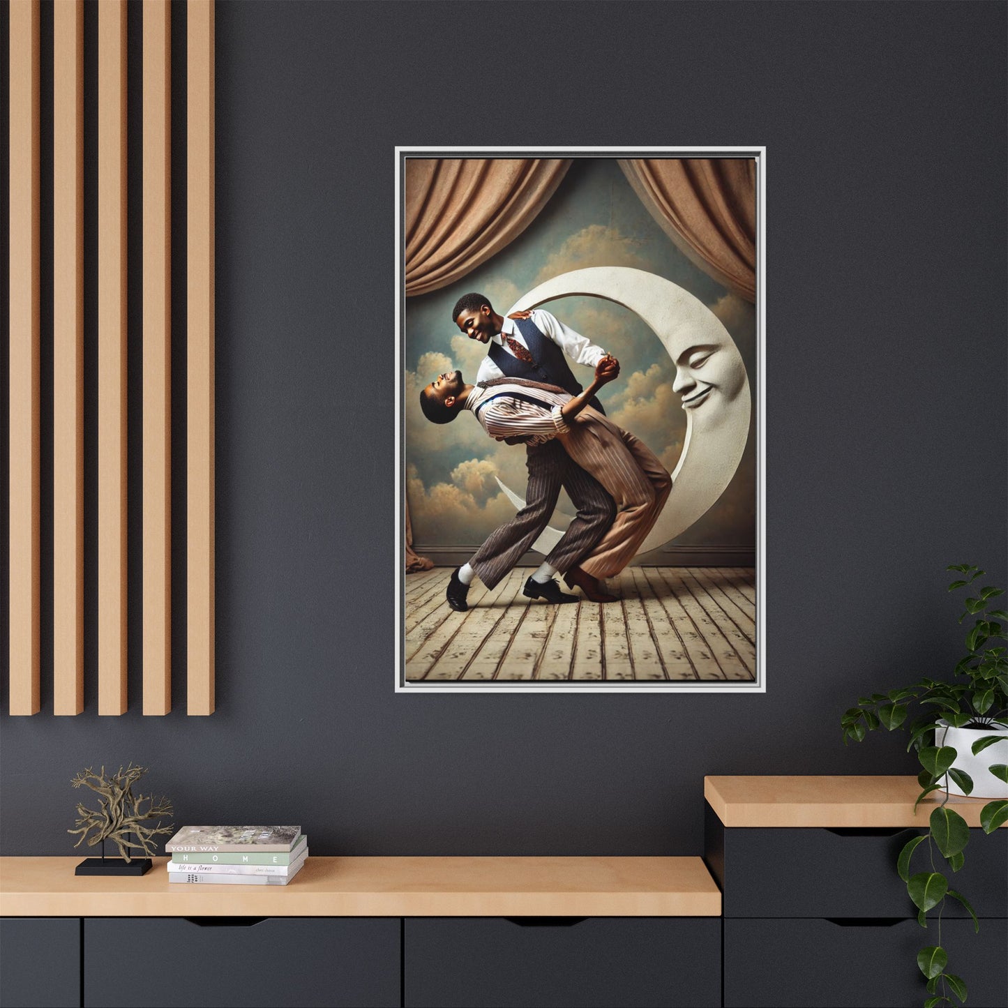 Framed artwork of two Black men in vintage suits dancing tenderly beneath a crescent moon with a smiling face. A romantic 1920s-inspired scene with velvet curtains and a painted sky backdrop. Part of a collection reclaiming lost queer Black history and art.
