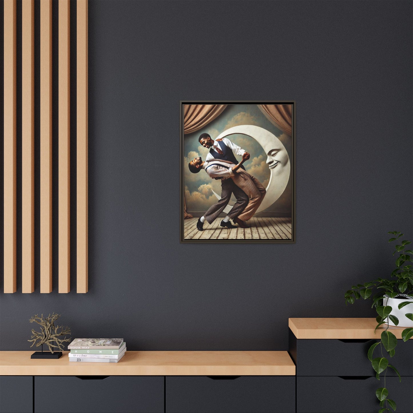 Framed artwork of two Black men in vintage suits dancing tenderly beneath a crescent moon with a smiling face. A romantic 1920s-inspired scene with velvet curtains and a painted sky backdrop. Part of a collection reclaiming lost queer Black history and art.