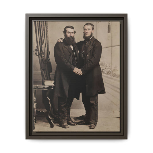 Historic studio portrait of two standing figures with draped backdrop