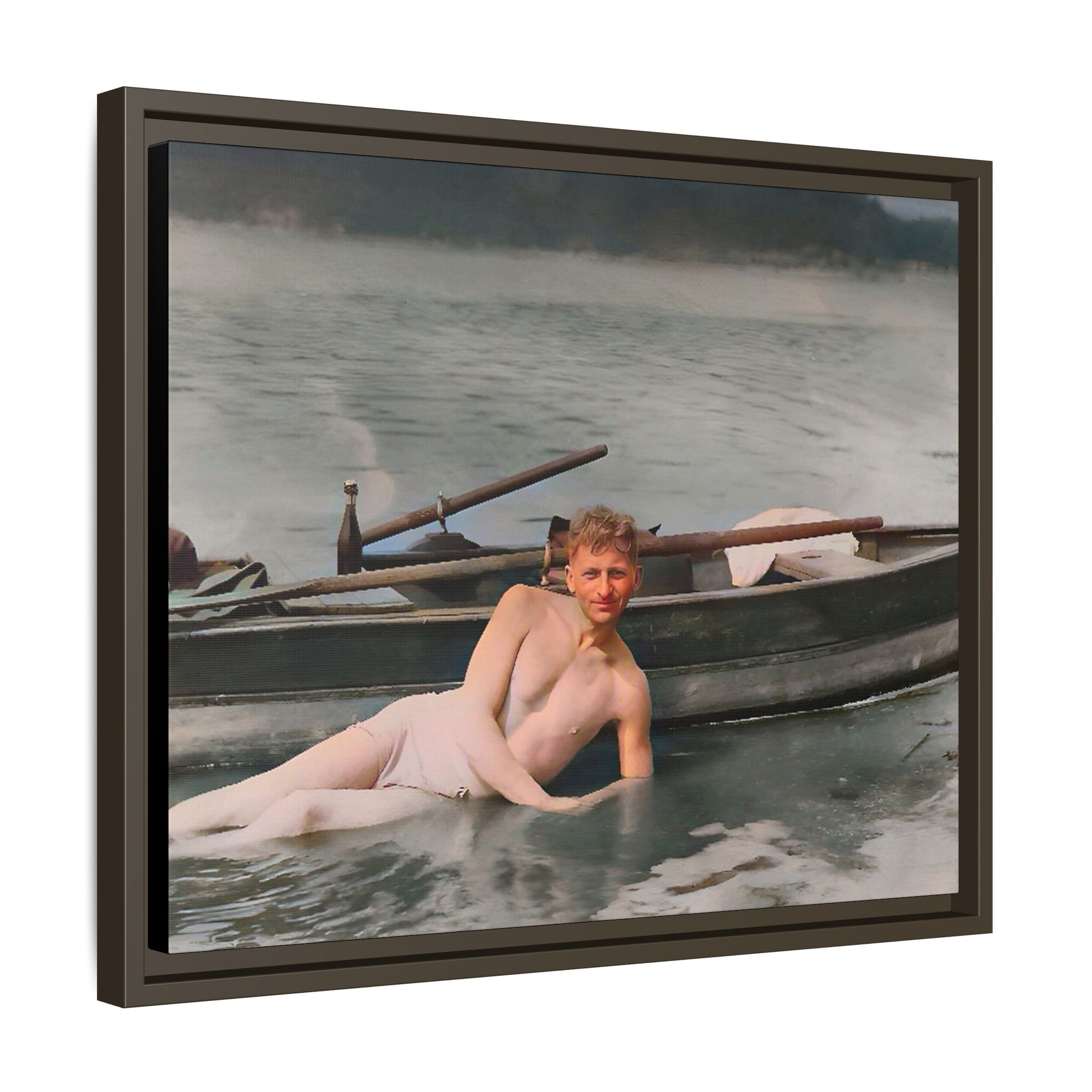 Restored vintage photo of Claude reclining by a rowboat on a calm lake in early 1900s Green Bay, Wisconsin. Framed matte canvas art celebrating serenity, history, and individuality.