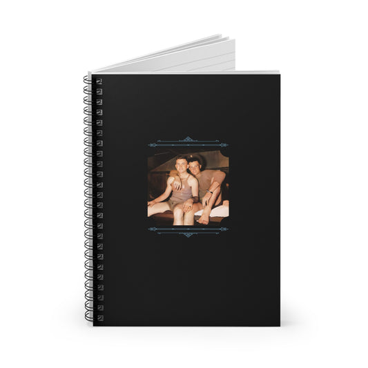 Black spiral notebook featuring a restored WWII-era photo of two young soldiers sharing a tender moment in barracks