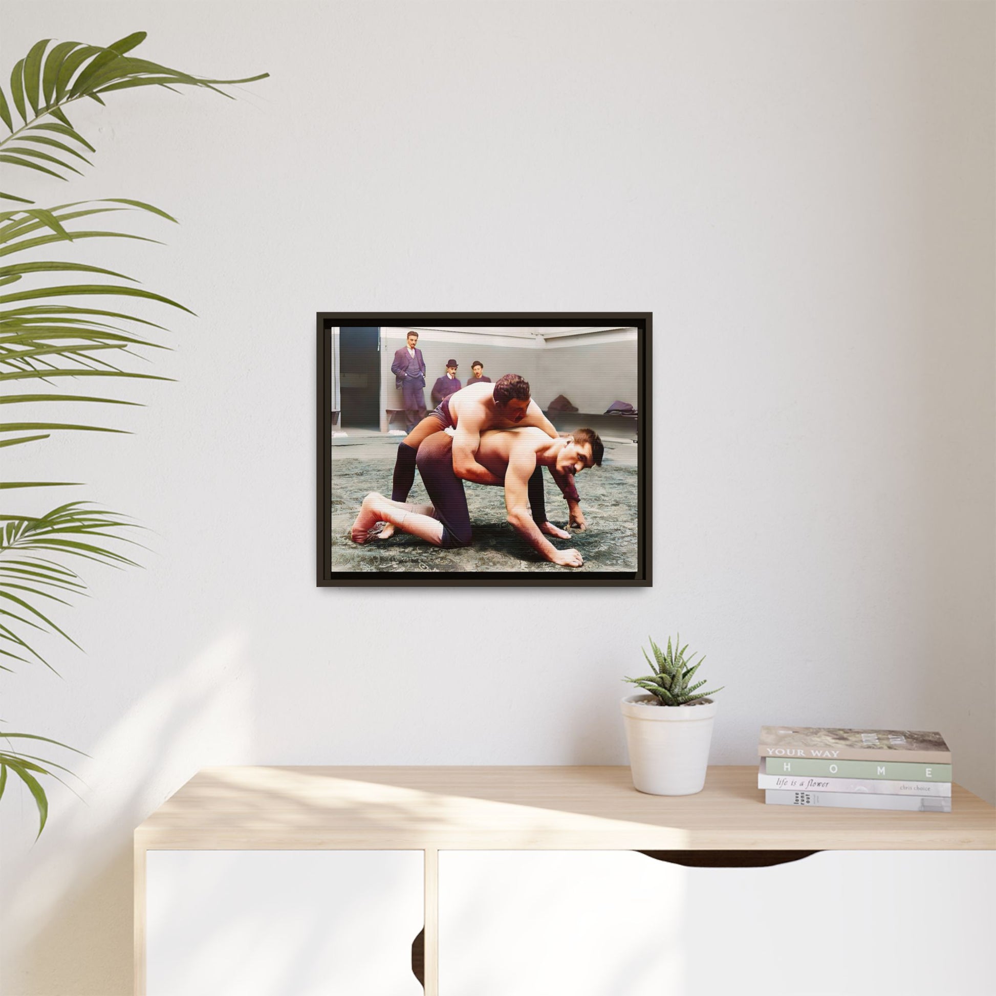 A framed vintage wrestling photograph on matte canvas featuring a Victorian-era match at Love’s Wrestling Club in Plumstead, UK, capturing strength and camaraderie.
