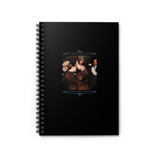 Black spiral notebook featuring a restored vintage photo of two men dancing closely in suits at a bar or ballroom