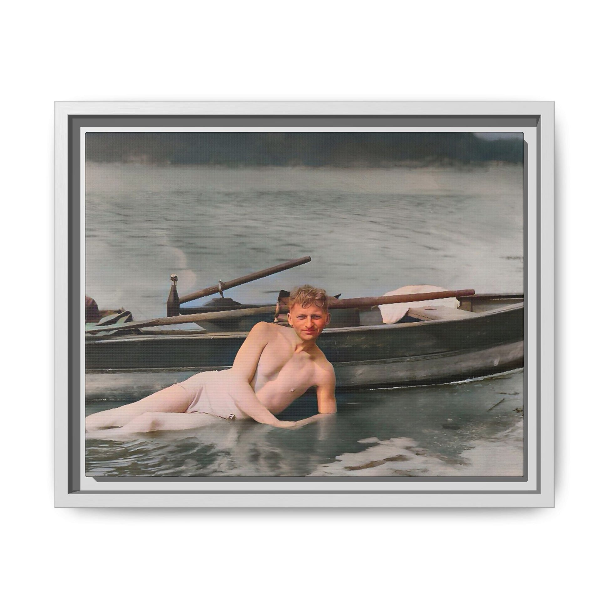 Restored vintage photo of Claude reclining by a rowboat on a calm lake in early 1900s Green Bay, Wisconsin. Framed matte canvas art celebrating serenity, history, and individuality.