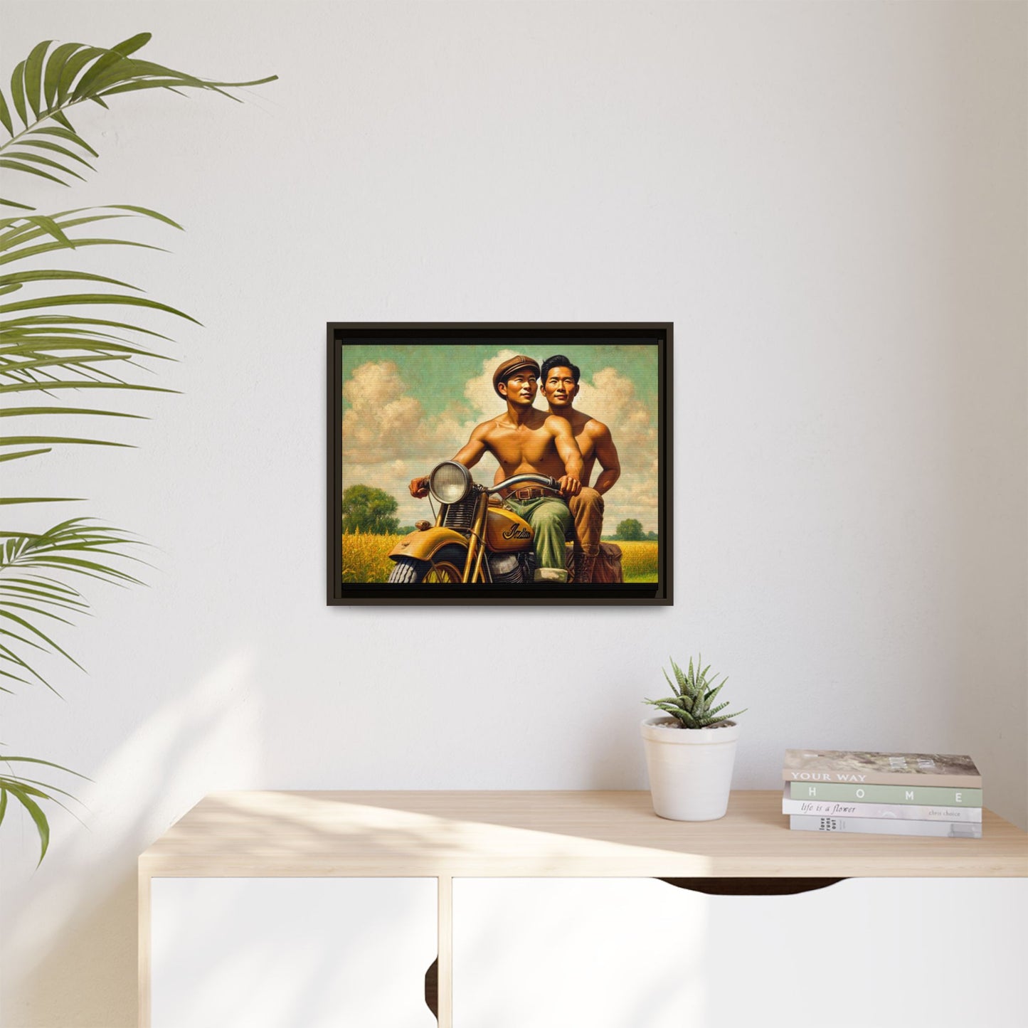 Framed artwork of an Asian-American gay couple riding a vintage yellow motorcycle through Iowa's serene countryside, celebrating love and unity.