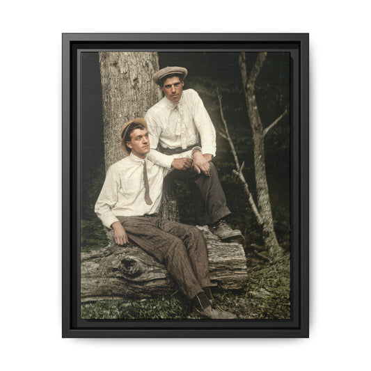 Vintage woodland portrait of two men seated on a log beneath a tree