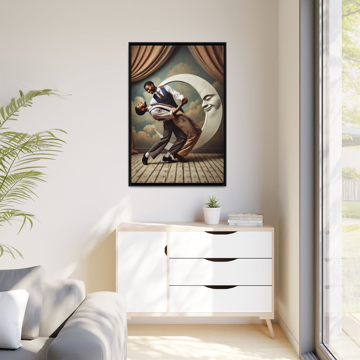 Framed artwork of two Black men in vintage suits dancing tenderly beneath a crescent moon with a smiling face. A romantic 1920s-inspired scene with velvet curtains and a painted sky backdrop. Part of a collection reclaiming lost queer Black history and art.