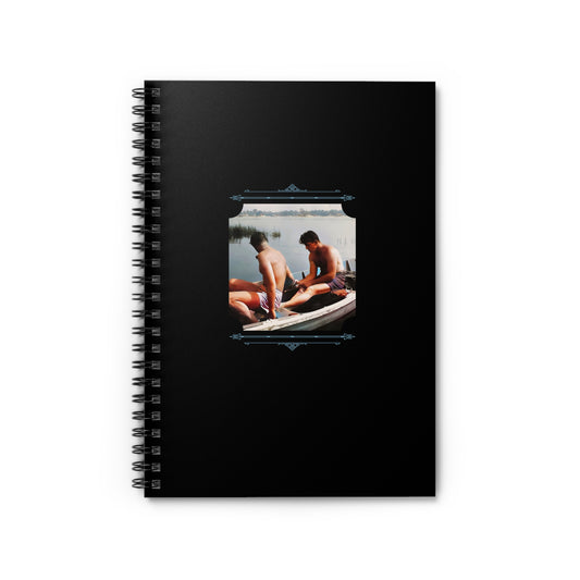 Vintage spiral notebook with a photo of two men sitting in a boat, sharing a quiet lakeside moment.