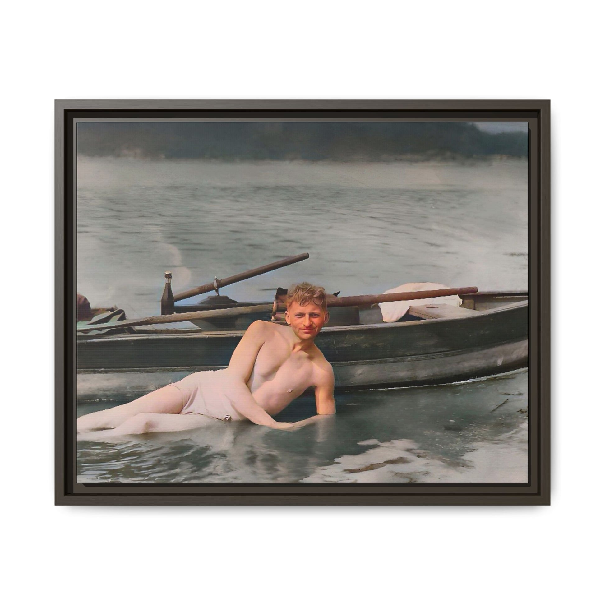 Restored vintage photo of Claude reclining by a rowboat on a calm lake in early 1900s Green Bay, Wisconsin. Framed matte canvas art celebrating serenity, history, and individuality.