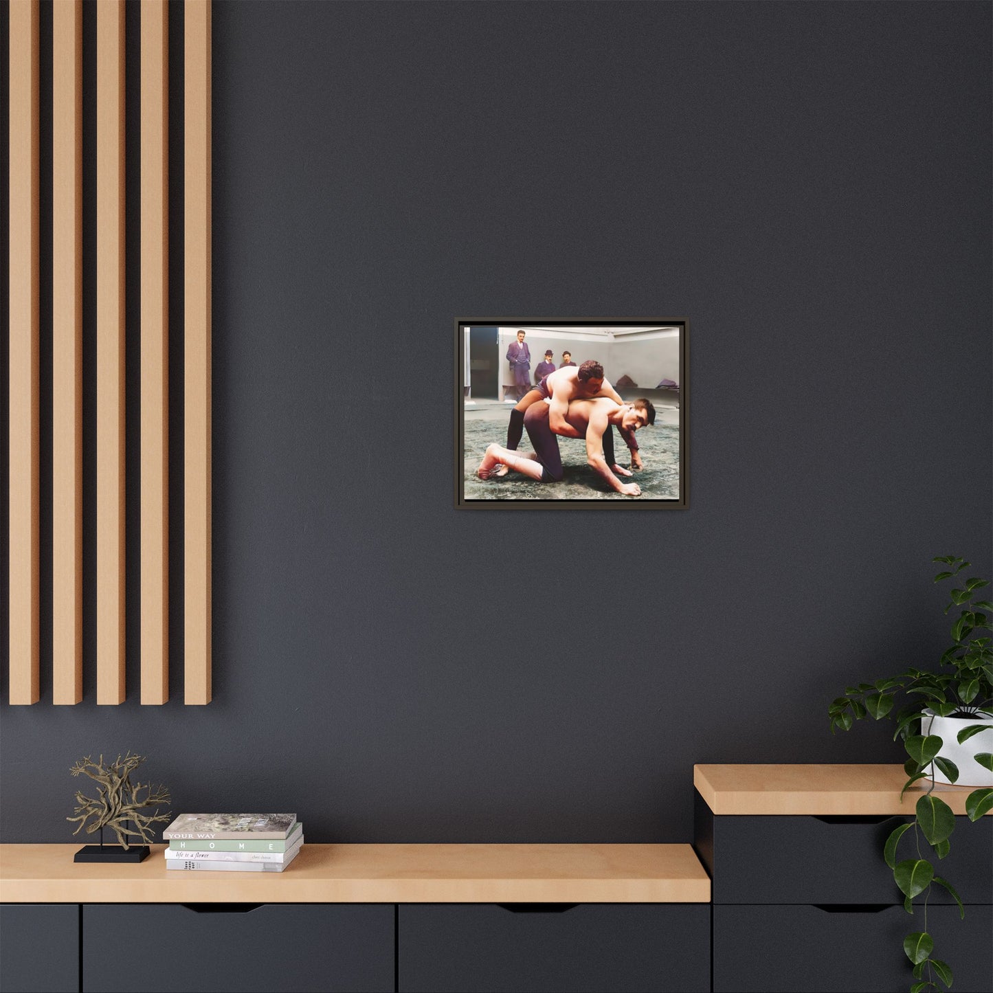 A framed vintage wrestling photograph on matte canvas featuring a Victorian-era match at Love’s Wrestling Club in Plumstead, UK, capturing strength and camaraderie.