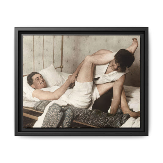 Early 20th century vintage photograph of two men reclining on iron bed interior
