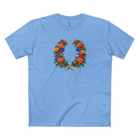 Mexican Cempasúchil Pride T-shirt featuring a laurel-style crown of golden-orange marigolds, muted Pride-colored flowers, and ORGULLO lettering below.
