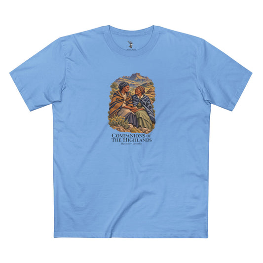 Dark T-shirt featuring two women in patterned blankets against a mountain landscape, with ivory Companions of the Highlands and Basotho · Lesotho lettering.